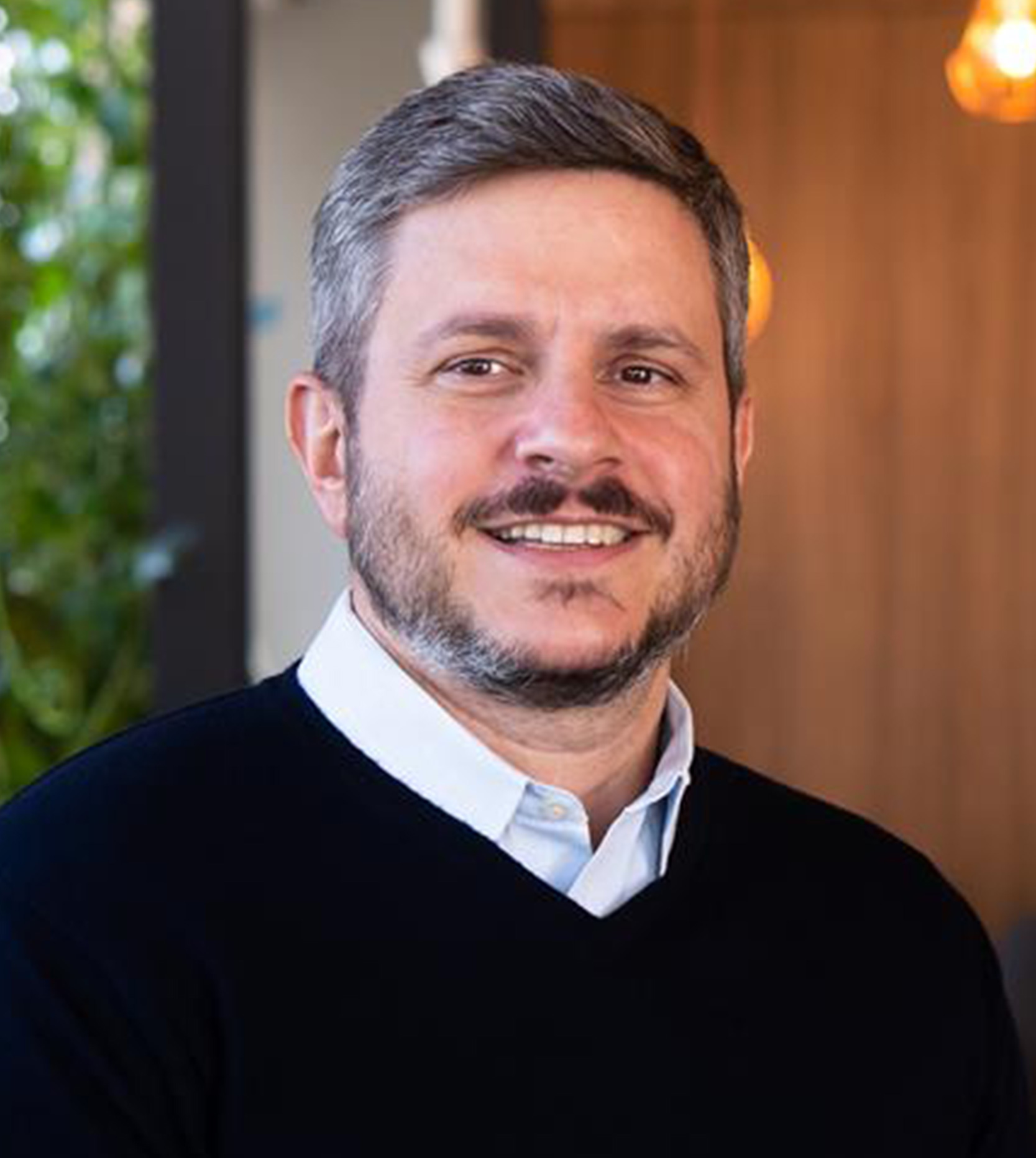 image of team in front of company building (for a roofing contractor)